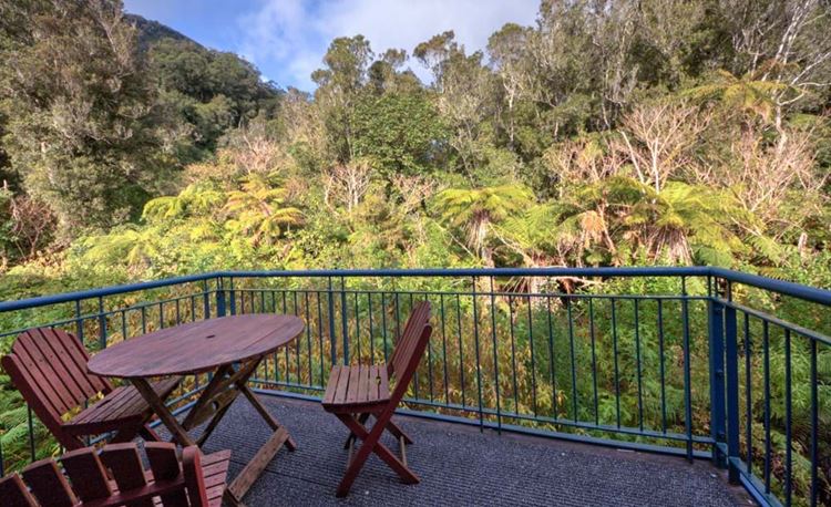 YHA Franz Josef outdoor eating area with forest view