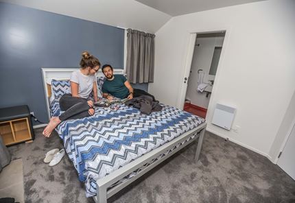 YHA Queenstown Lakefront youth travelers planning in double bedroom ensuite