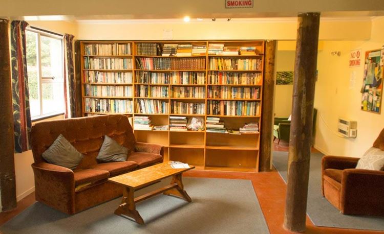 YHA Whangarei lounge area with bookshelf