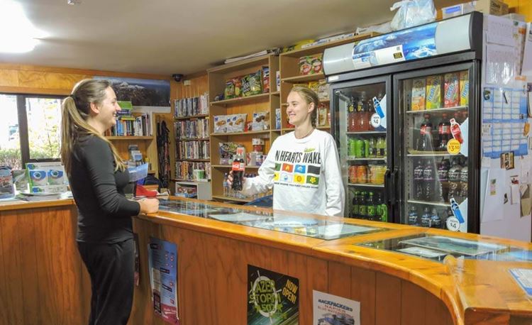 YHA National Park youth traveler buying a cola from reception