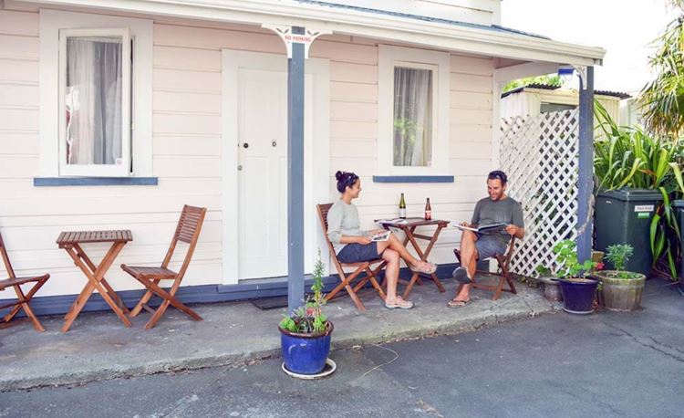 YHA Whanganui youth travelers enjoying wine in outdoor area