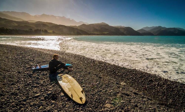 yha Kaikoura surfer looking for waves to catch