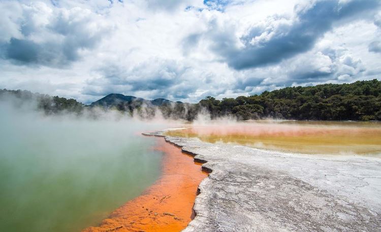 Steam floating above the orange the green champagne pool at Rotorua's geothermal wonderland Wai-O-Tapu.