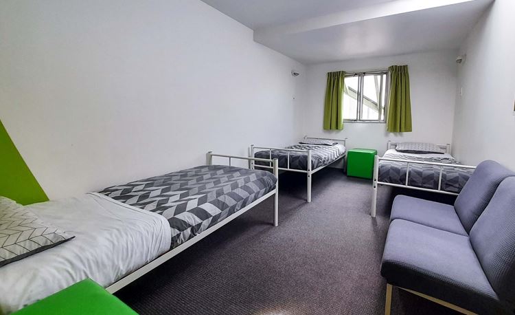 Private Triple bedroom accommodation with three single beds at YHA Nelson