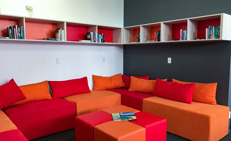 Reading corner with couches and shelving at YHA Nelson